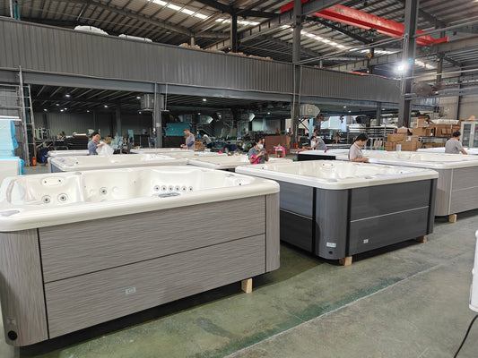 Valora factory team inspecting completed hot tubs before water testing and packing