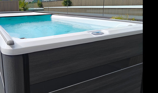 Valora swim spa with its electric cover partially open during a pre-use visual check