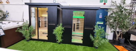 Two dark exterior sauna cabins displayed at East Yorkshire Showground in 2025