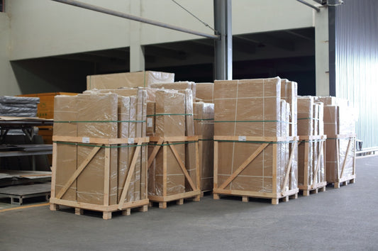 Protected sauna packages secured on pallets at the Valora factory before shipment